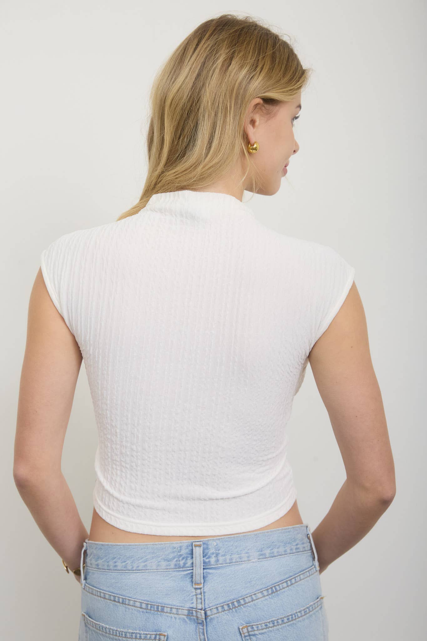 ASYMMETRICAL HEM MOCK NECK SLEEVELESS TOP